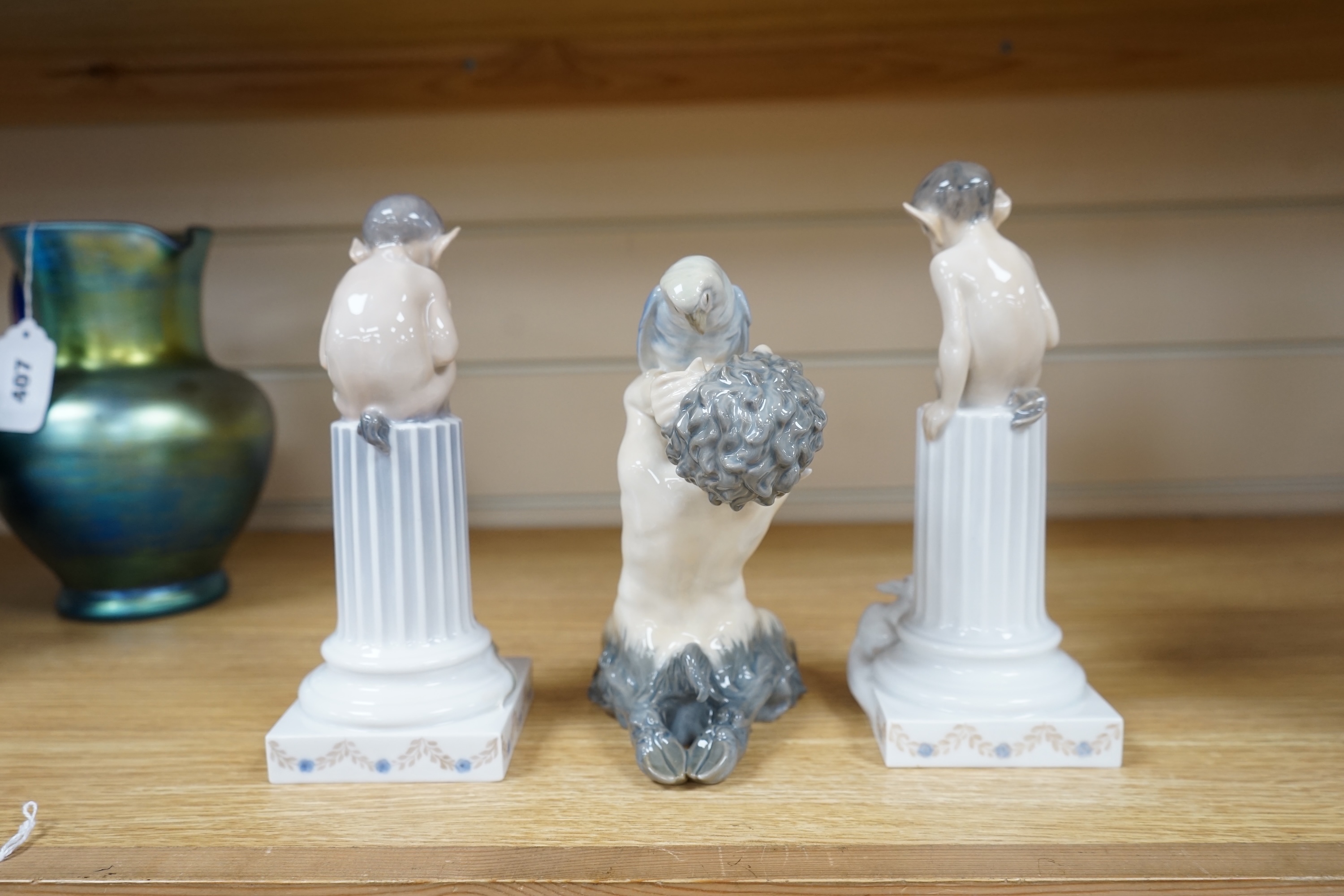 Three Royal Copenhagen groups of fauns, model numbers 752, 456 and 433. Tallest 21cm. Condition - some professional, minor restoration